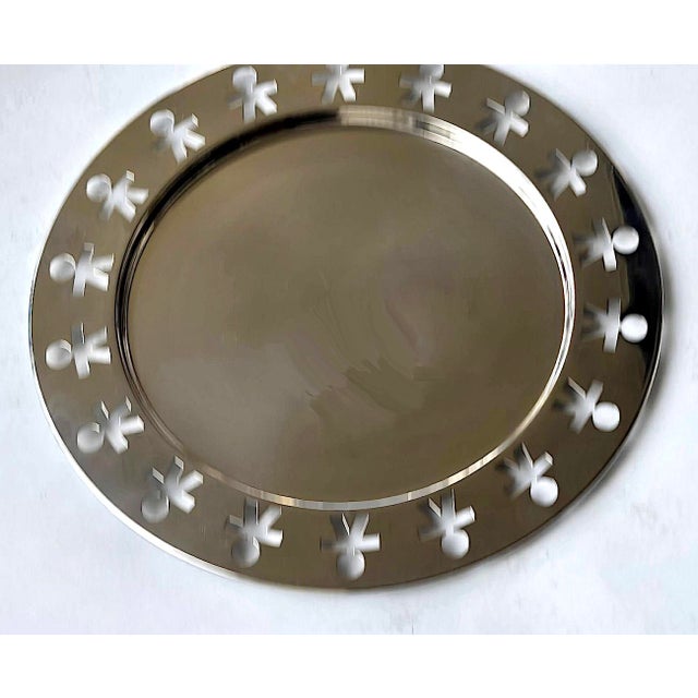 Offered is a vintage Alessi Girotondo tray with cut out paper dolls motif in mirror finish 18/10 Stainless Steel, designed...