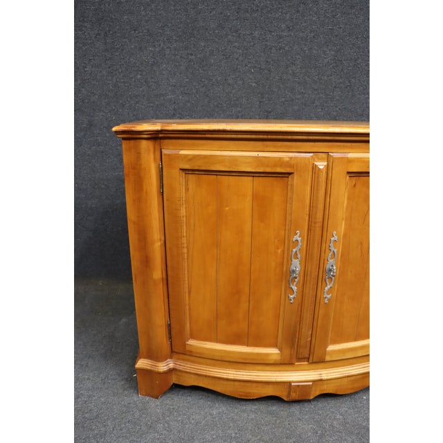 Ethan Allen French Country sideboard crafted in cherry wood, featuring a shaped top with a gently bowed front, paneled...
