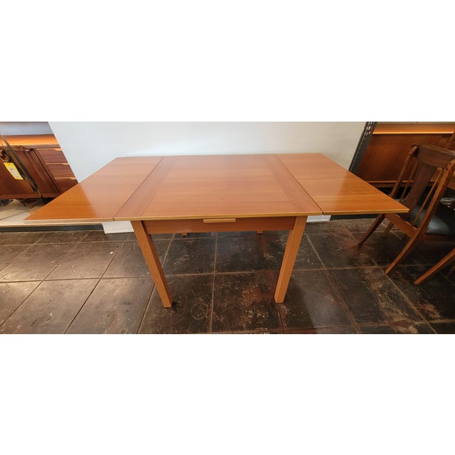 A nice Danish Modern Gangso Mobler teak dining table. Draw leaf great for small space. One pull out leaf on each side. (2)...