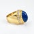 Enhance your collection with this striking 18k yellow gold ring, a masterpiece of refined design. At its center, a...