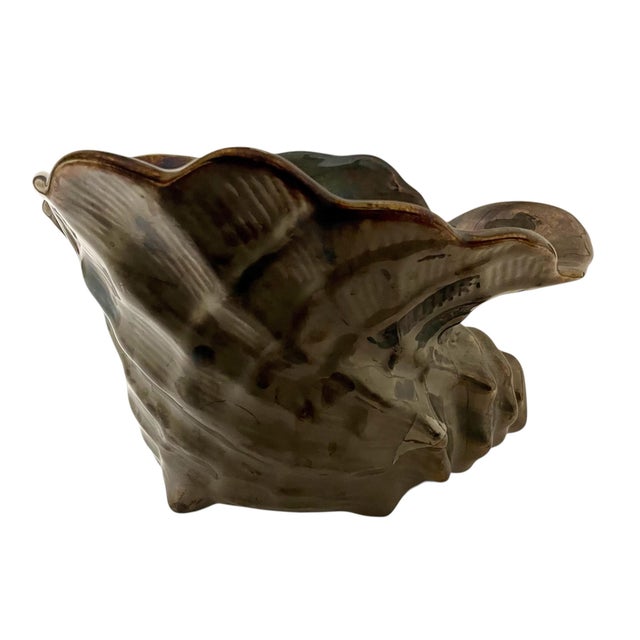 The Vintage Destinos S.A. Portugal Bronze Ceramic Conch Shell Planter Pot Vase is a unique and stylish addition to any...
