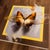 This artwork features a striking depiction of a butterfly, its wings adorned with rich shades of orange and brown, set...