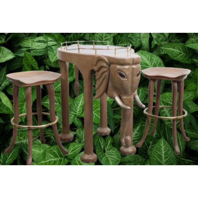 A spectacular whimsical Hollywood Regency style rolling bar cart carved and shaped like an elephant, complete with...