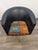 This vintage 1960s club swivel chair features black upholstery and a colorful, patterned seat cushion. Metal legs provide...
