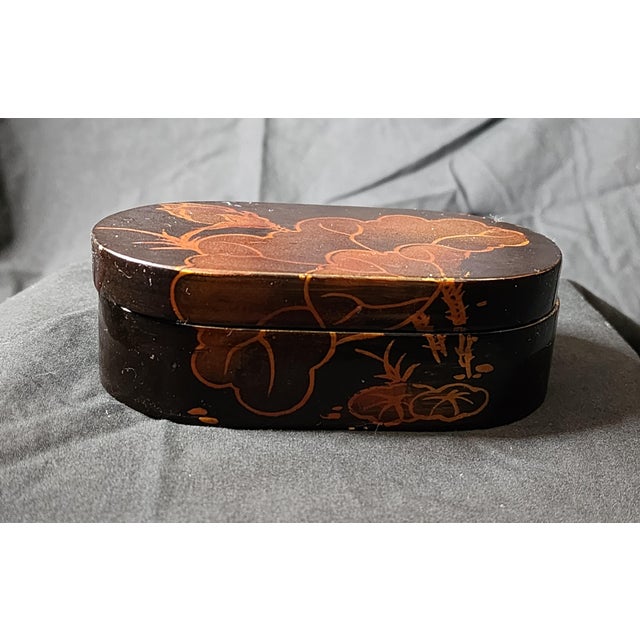 Antique Japanese lacquerware box, featuring makie decoration where metal powder is sprinkled over wet lacquer to create...