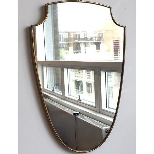 Mid-century italian wall mirror with brass frame (circa 1960s). This mirror is simply elegant and characterful in a...