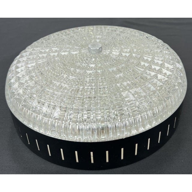 An elegant Vintage French ceiling lamp with a low-profile circular form, decorative clear patterned glass shade and...