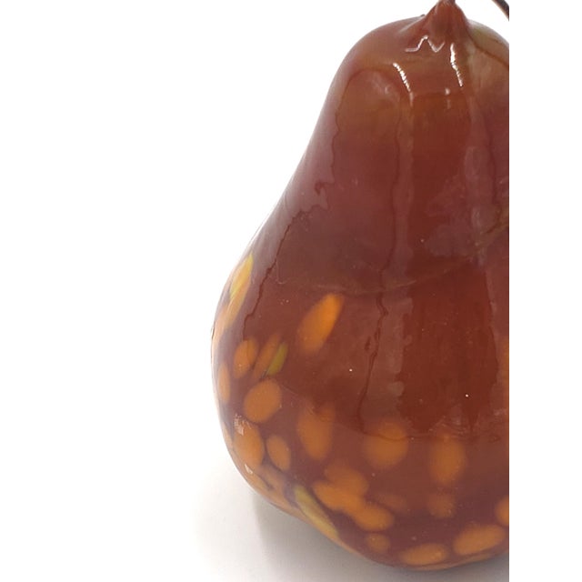 This lovely miniature glass pear is brown with gold speckles. It has a wire stem and the original sticker that reads "Made...