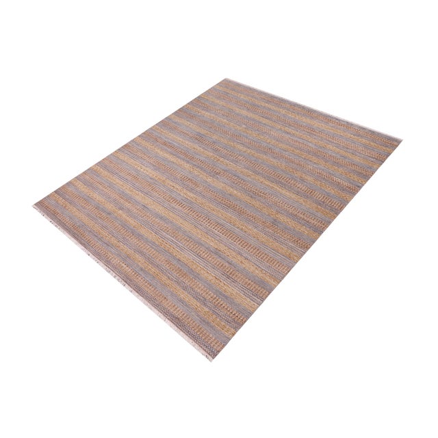 Elevate your interior with this hand-knotted high-low wool area rug, designed to bring depth and dimension to any room....