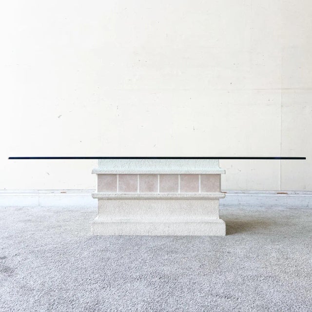 Amazing vintage postmodern rectangular beveled glass top coffee table. Feature a white stucco finish with a pink ceramic...