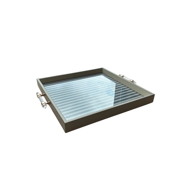 These functional serving trays feature a lightly distressed ivory frame with clear acrylic and gold accent handles in...