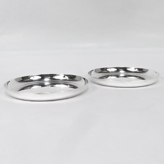 A pair of fine signed English Mid-Century silver wine coasters. By Asprey & Co. In heavy-gauged sterling silver. Each with...