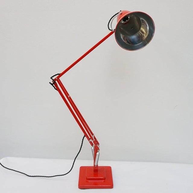 Three-spring' chromed and polished red painted anglepoise desk lamp by herbert terry & sons. Two step base and perforated...