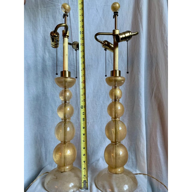 Mid century vintage Murano glass table lamps with 24-karat gold flecks embedded throughout the clear glass. Adjustable...