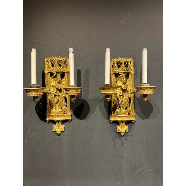 A pair of late 19th century gothic style Caldwell sconces with St Michael motif