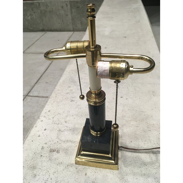 Postmodern black marble and brass two light desk lamp having brass ball pull strings, circa 1980s.