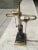 Postmodern black marble and brass two light desk lamp having brass ball pull strings, circa 1980s.