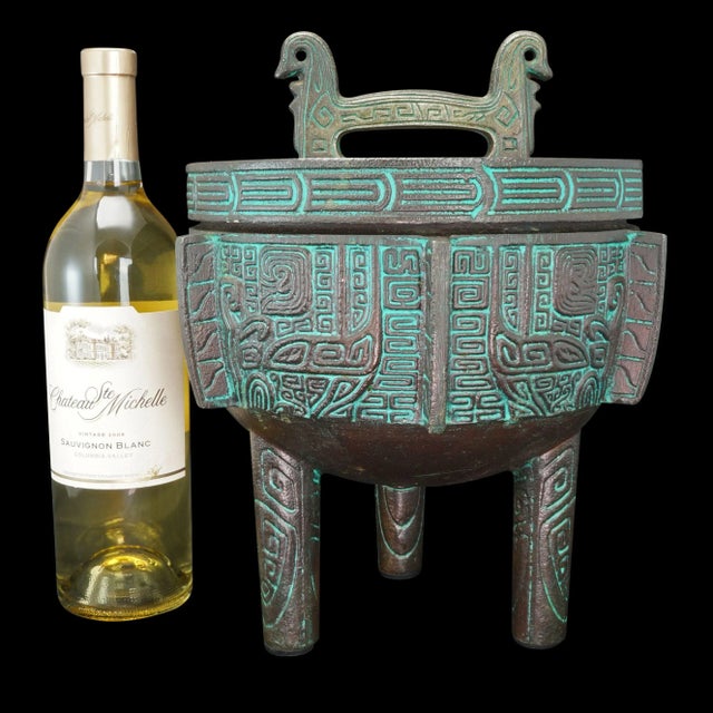 A large ice bucket by James Mont in the shape of a Chinese Bronze Ritual Vessel. The molding is deep and rounded with a...