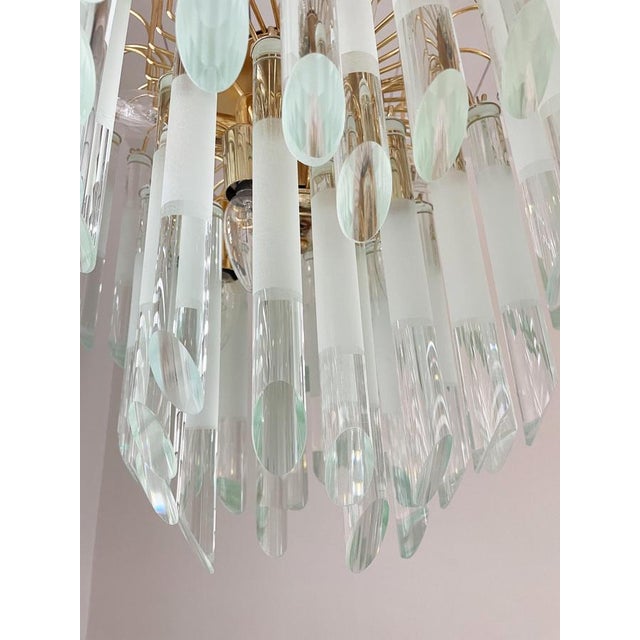 Striking chandelier in the manner of Paolo Venini with cut glass droplets with matte parts. The chandelier emits a...
