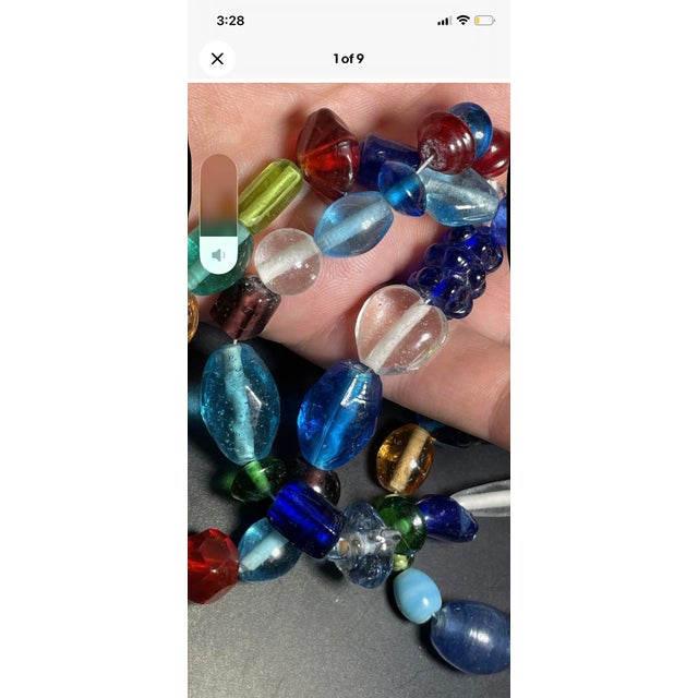 pressed glass bead necklace crafted from glass beads formed by squeezing molten glass rods into custom metal dies or...