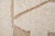 Natural hand-knotted wool rug in soft Ivory with geometric Beige accents. The raised patterns and neutral tones create a...