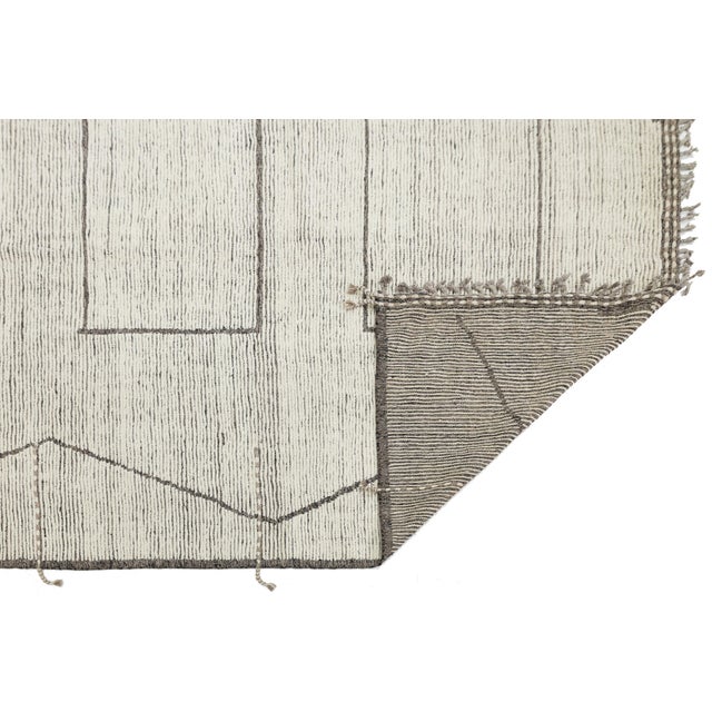 Elevate your space with this sophisticated Modern Moroccan-style rug, a perfect blend of ancestral weaving techniques and...