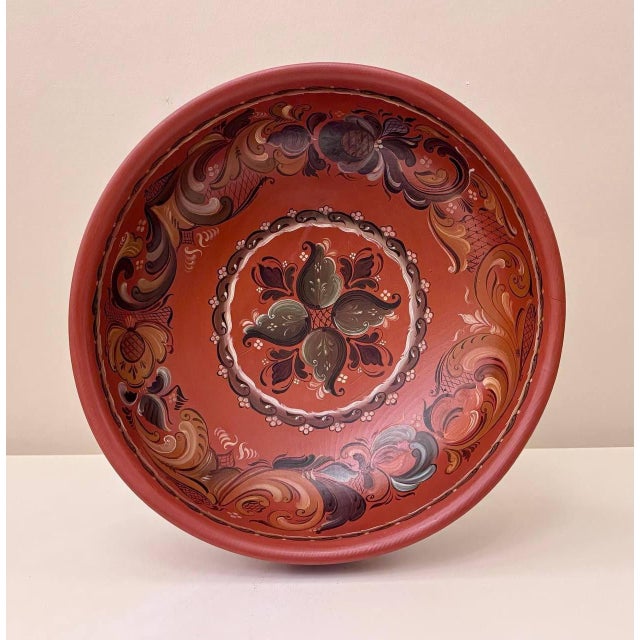 A vintage Norwegian hand-painted wooden bowl dated 1983, decorated in a rosemaling-inspired folk-art style. The interior...