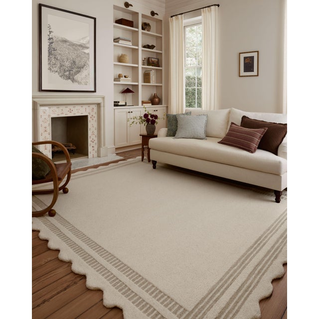 The Scottie Collection from Chris Loves Julia x Loloi is a hand-tufted wool area rug with a playful scalloped edge and...