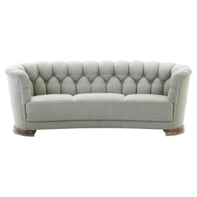 Sizable and very elegant Danish 1930-40s curved sofa raised on a beech frame and legs. These type of sofas was...