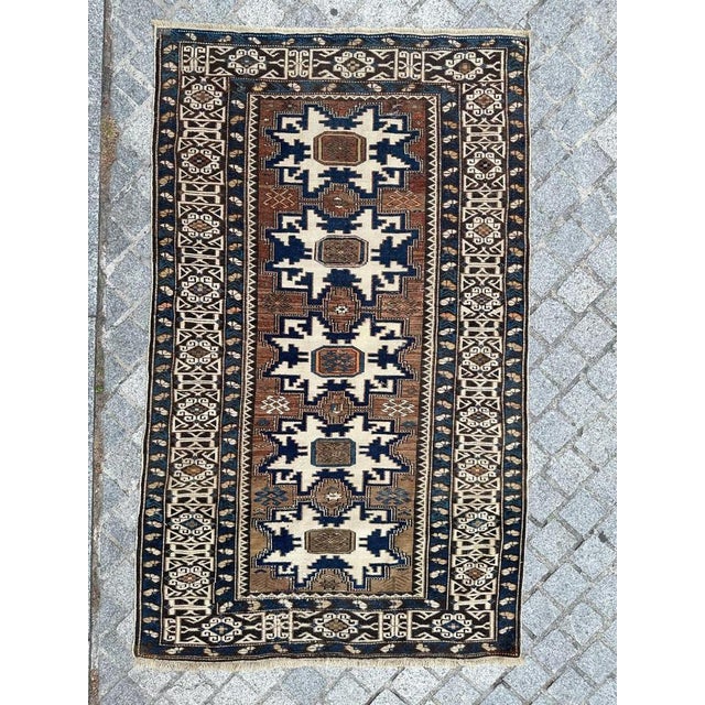 "Discover the timeless beauty of this exquisite antique Shirwan Caucasian rug. This masterpiece features a captivating...