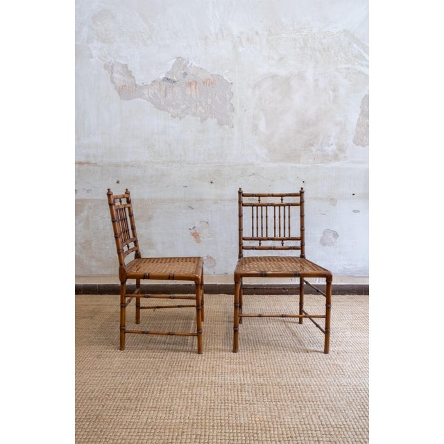 Faux bamboo and vienna straw dining set – 1970s comprising a rectangular dining table and six matching chairs. Turned wood...