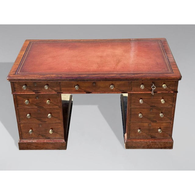 A stunning 19th-century mahogany partners desk by Holland & Sons. Nine drawers on one side and two cupboards on the other....