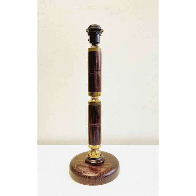 Mid-Century dark pine and brass lamp Aneta Sweden. The wood has beautiful markings and shine. The on and off button is...