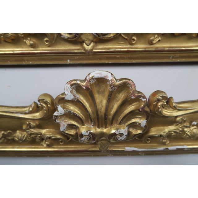 19th century French gilt wood carvings with a center shell motif flanked by garlands of flowers.