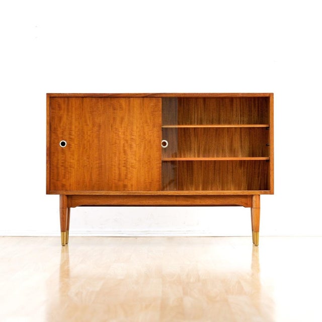 This vintage mid-century china cabinet by Herbert. E Gibbs is a wonderful design and excellent storage piece. Made from...