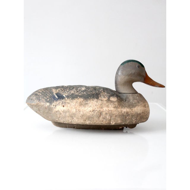 Vintage hand-painted mallard duck decoy with a broad, sculptural silhouette, carved wing detailing, and a beautifully...