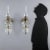 Pair of crystal wall lamps, made with fake oil lantern light, glass bobeches and pendants. Italy, 20th century. This piece...