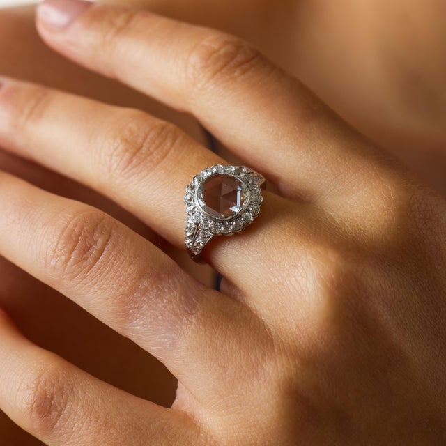 This exquisite Edwardian diamond cluster engagement ring from the 1910’s is a breathtaking example of antique romance and...