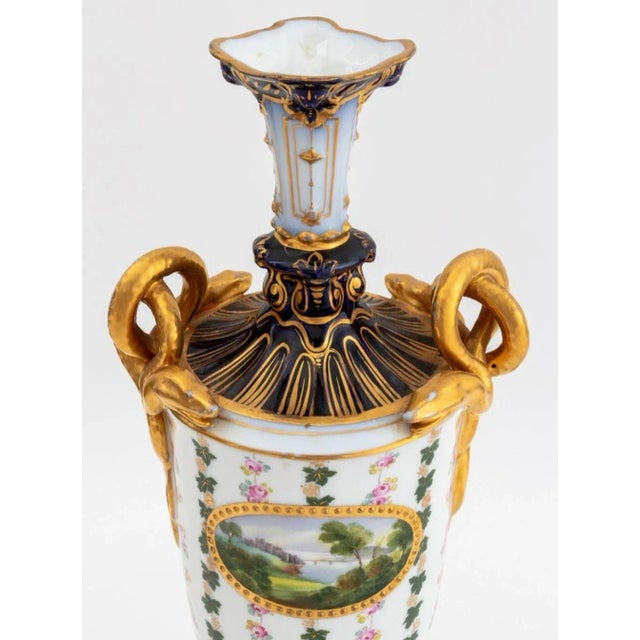 German Porcelain Two Handle Vase, late 19th century, with snake entwined handles, oval painted landscape panel, signed...