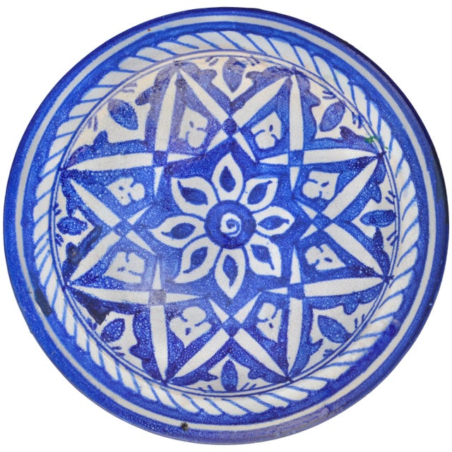 Spectacular antique Moroccan ceramic decorative plate meticulously handcrafted and glazed in a sleek silhouette exhibiting...