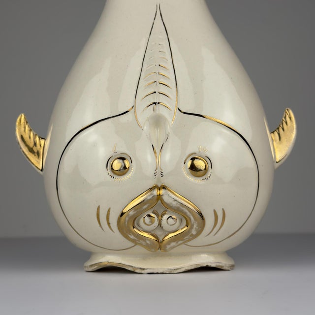 Vintage Italian ceramic vase in the form of a stylized fish, circa 1950s. The sculptural body is finished in ivory-white...