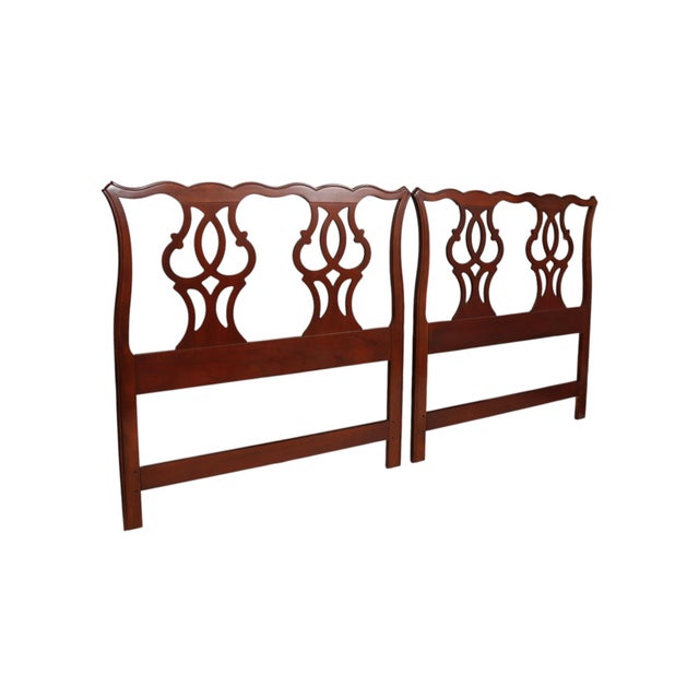 A pair of Chippendale style twin headboards made by Drexel Heritage Furnishings, Inc. Mahogany frames are carved with...