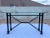 Giacometti style faux wrought iron welded steel console sofa table with a patinated bronze verdigris finish and beveled...