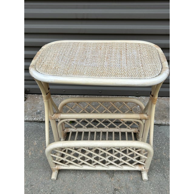 Lovely small rattan magazine holder table. In very good condition