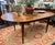 An exceptional antique country harvest style oval dining table crafted from solid wood. Featuring a four plank Top in a...