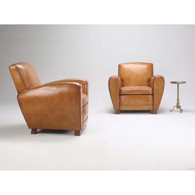 Enhance your living space with this exquisite Pair of Art Deco French Leather Club Chairs from Antique Item. Crafted in...