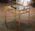 Crafted in France circa 1950, and attributed to Maison Baguès in Paris, this elegant brass table is both useful and...