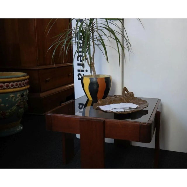 Italian design coffee table, lacquered walnut veneer frame with elegant smoked glass top. It was designed by GIANFRANCO...