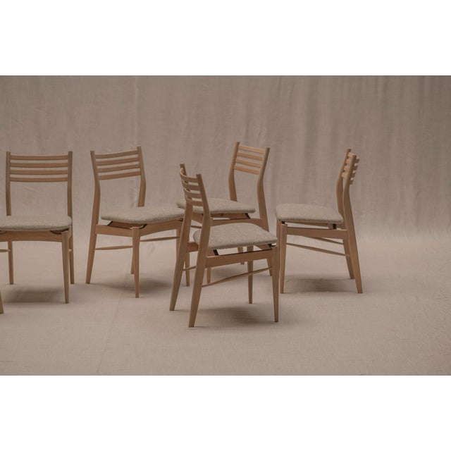 Elegant set of six Danish modern dining chairs from the 1960s, beautifully restored and professionally reupholstered in a...