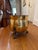 An antique hammered brass cauldron planter with three clawed feet and lion head accents. H: 12.5” D: 12.5” Depth: 10”